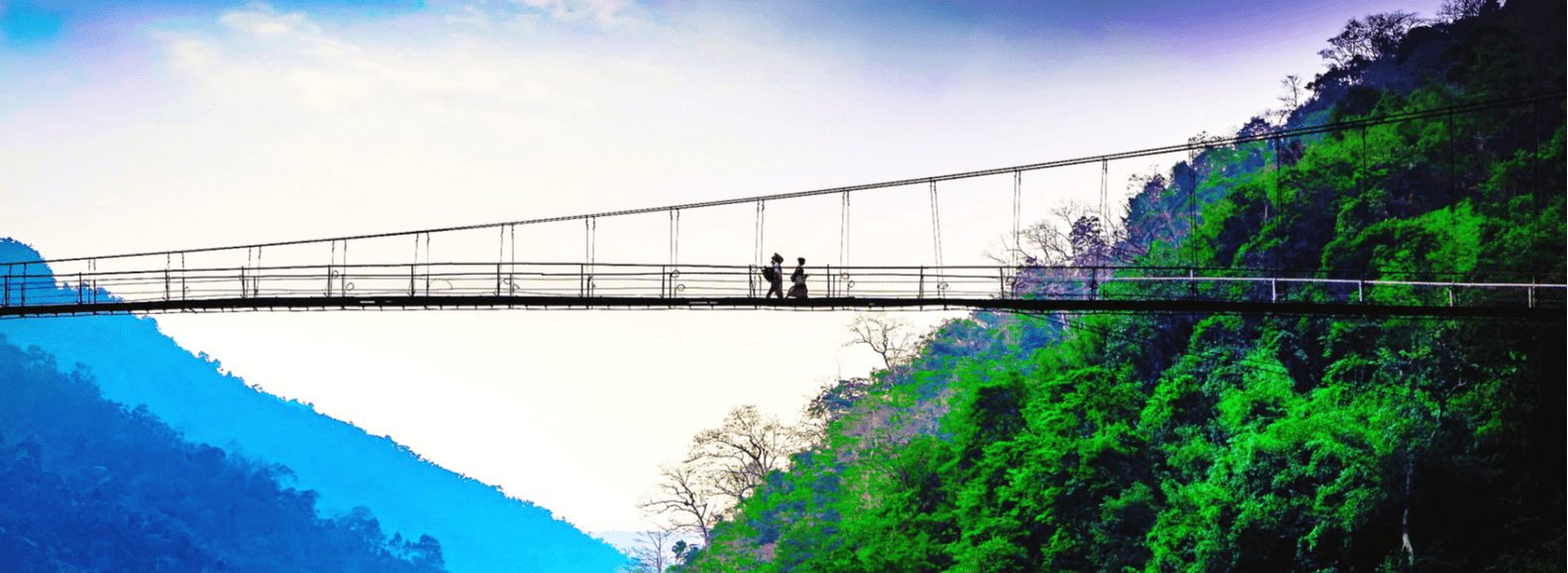 2 people walking on a bridge in Shillong