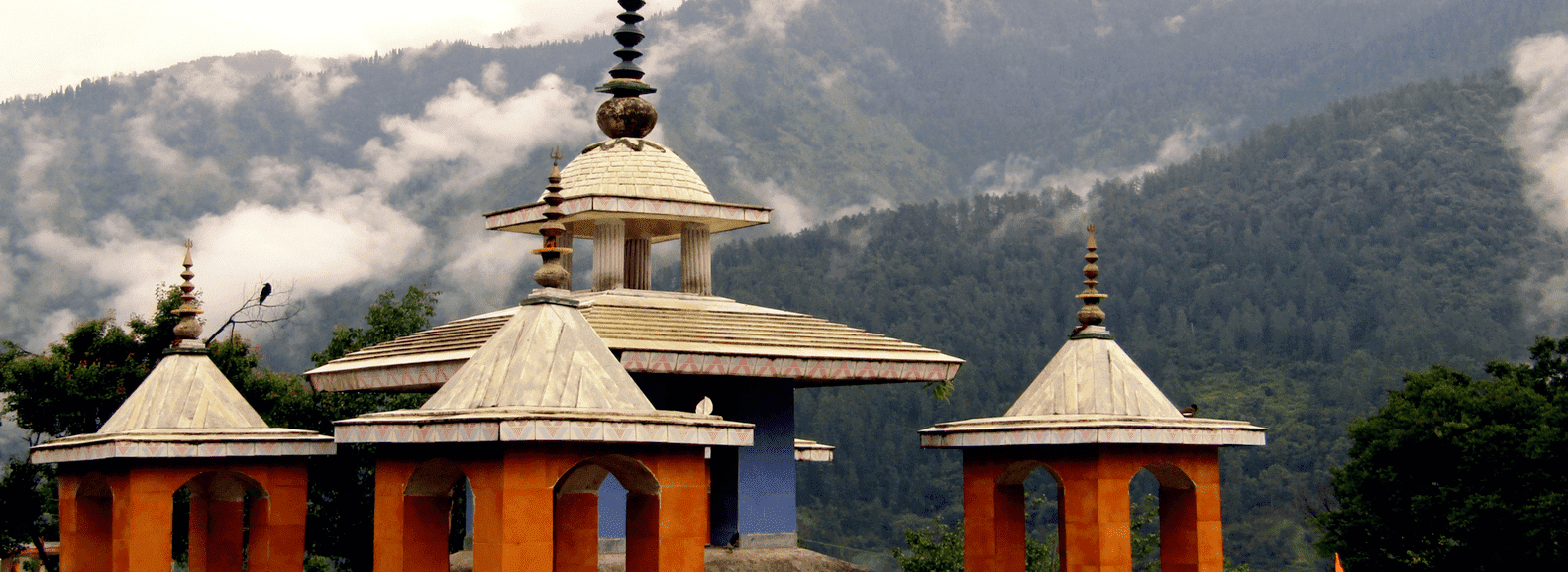 Uttarkashi temple image in Ganga valley Uttarakhand with clouds and mountaind behind